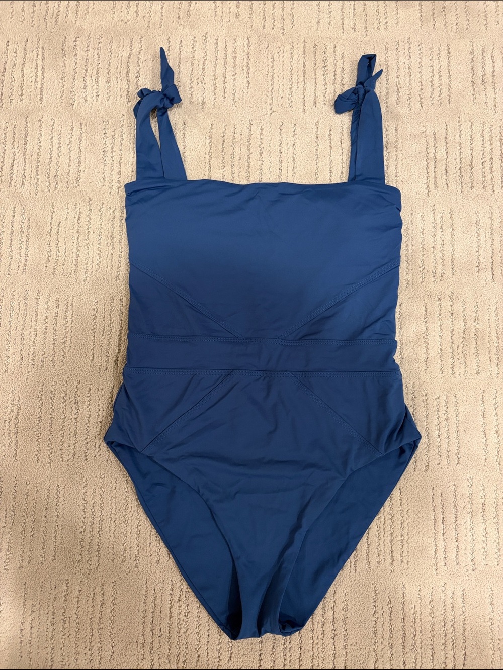 Royal blue one piece by Becca with tie shoulders and back